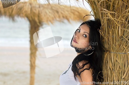 Image of Nice young brunette on a beach