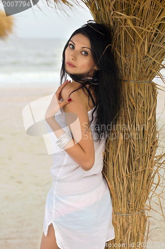 Image of Pretty young brunette on a beach