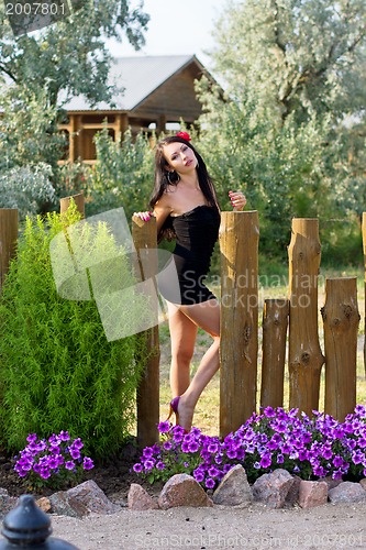 Image of Pretty young woman in black dress