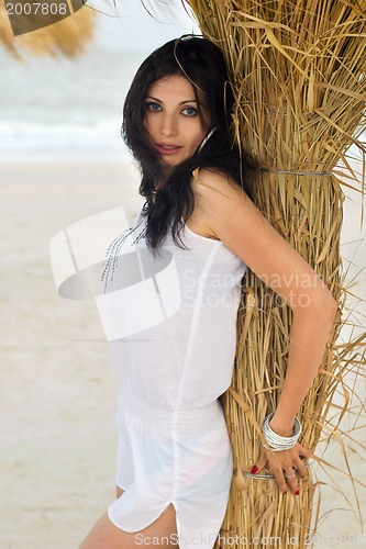 Image of Beautiful young brunette on a beach