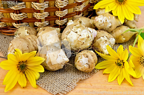 Image of Jerusalem artichokes with yellow flowers and a basket