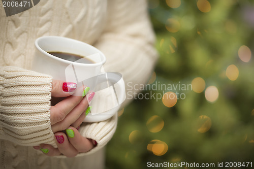 Image of Woman with Red and Green Nail Polish Holding Cup of Coffee