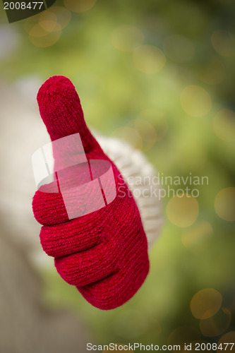 Image of Woman Wearing Red Mittens Holding Out Thumbs Up Hand Sign