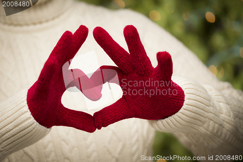 Image of Woman Wearing Red Mittens Holding Out a Heart Hand Sign