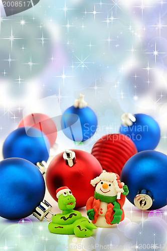 Image of Christmas card with snake and cheerful snowman. 