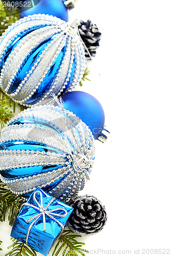 Image of Christmas card with blue balls and cones.