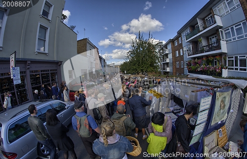 Image of LONDON - SEP 28: Visitor watches shops and market on September 2