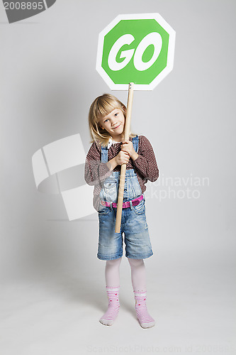 Image of Young girl holding go sign