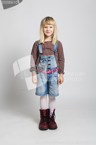 Image of Happy girl wearing adult sized boots