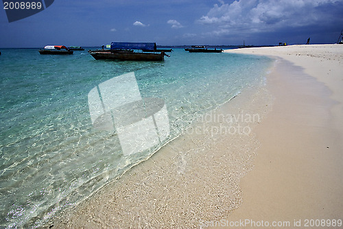 Image of beach and boats in sand bank  zanzibar