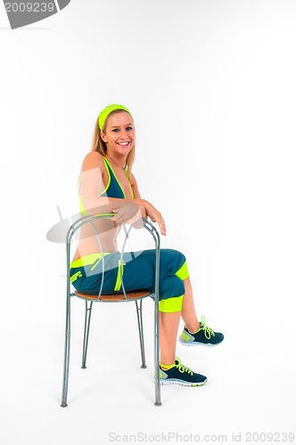 Image of Young fitness instructor sitting on chair