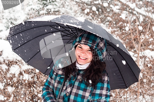 Image of Girl with umbrella in the snow