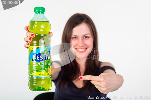 Image of Cheerful young adult with refreshing drink