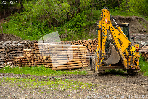 Image of Construction machine and a pile of boards