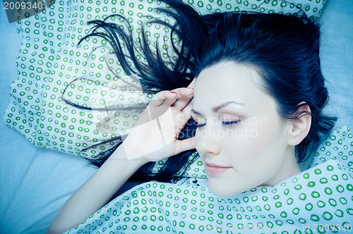Image of Young woman in the bed