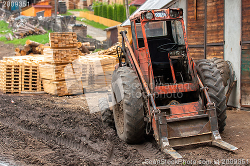 Image of Wood industry outdoorsm with red tractor