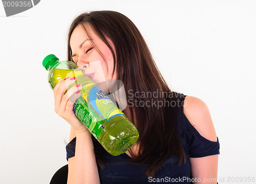 Image of Cheerful young adult with refreshing drink