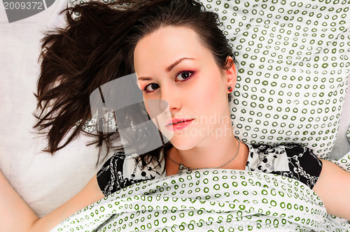 Image of Young woman in the bed