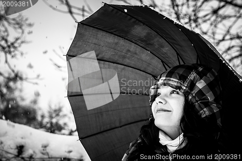 Image of Girl with umbrella in the snow