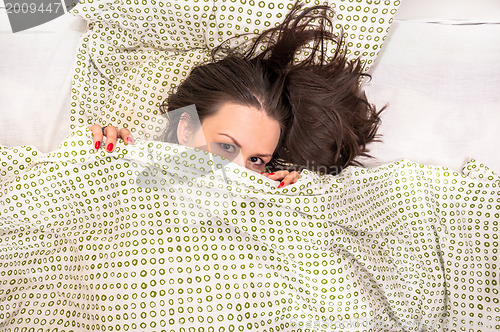 Image of Young woman in the bed