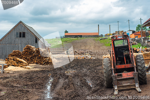 Image of Wood industry outdoorsm with red tractor
