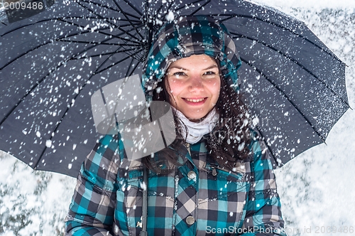 Image of Girl with umbrella in the snow