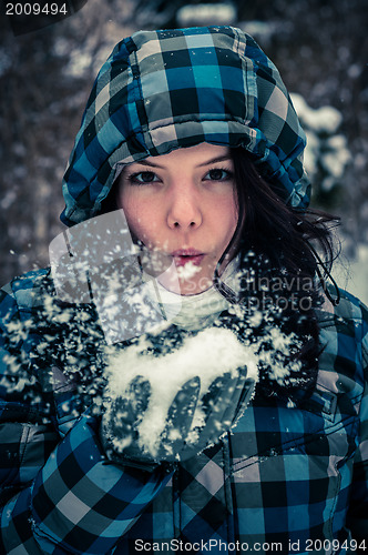 Image of Attractive young woman with snow in her hand