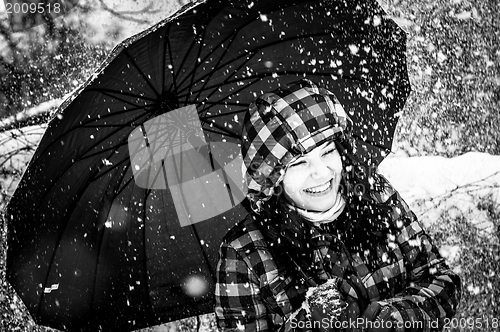 Image of Girl with umbrella in the snow