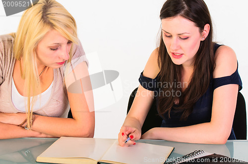 Image of Two beautiful student girls getting ready for school