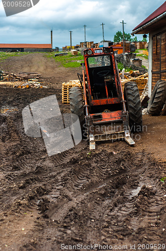 Image of Red tractor in the mud