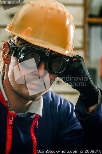 Image of Hard working man in helmet