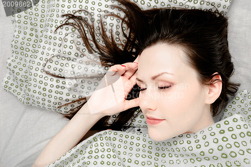 Image of Young woman in the bed