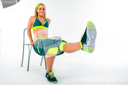 Image of Young fitness instructor sitting on chair