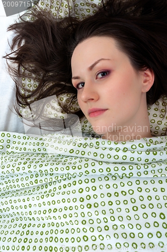Image of Young woman in the bed
