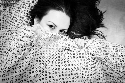 Image of Young woman in the bed
