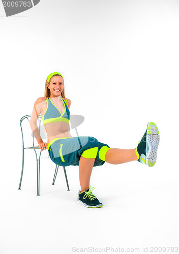 Image of Young fitness instructor sitting on chair