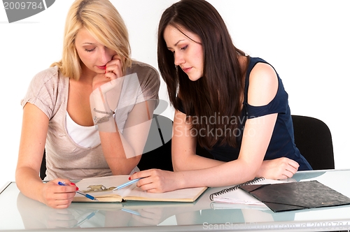 Image of Two beautiful student girls getting ready for school