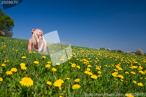 Image of young woman lying on a meadow