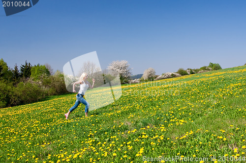 Image of happy young woman on meadow