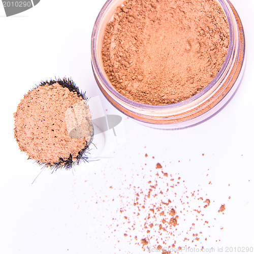 Image of makeup brush and powder