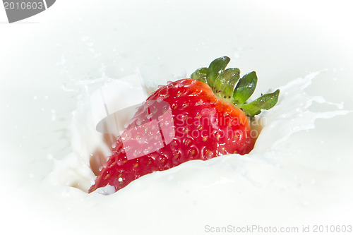 Image of strawberry splashing into milk