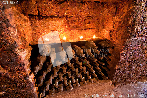 Image of wine bottles with candles