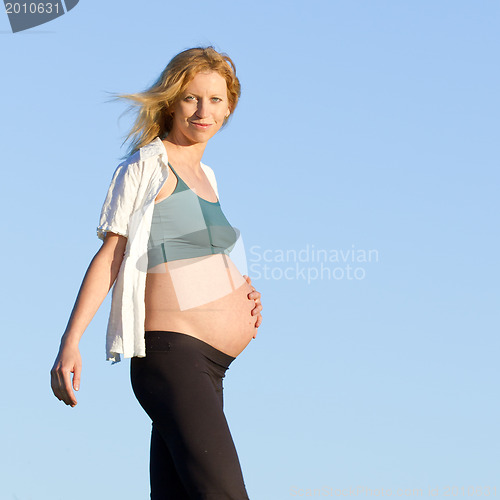 Image of pregnant woman on meadow