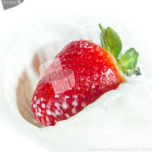 Image of strawberry splashing into milk