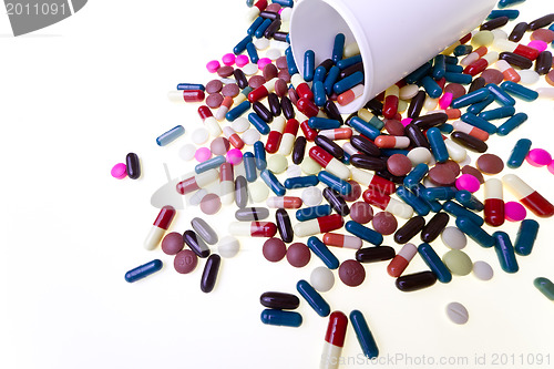 Image of pills spilling out of container 