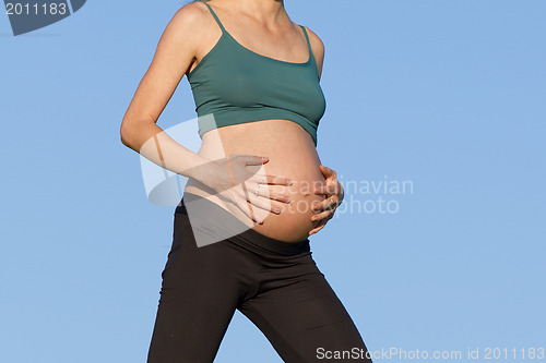 Image of pregnant woman on meadow