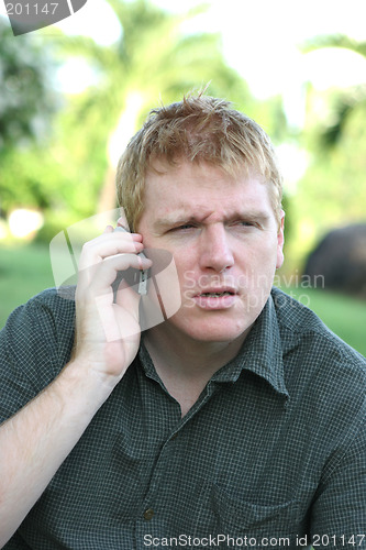 Image of Man on the phone with a angry or confused expression