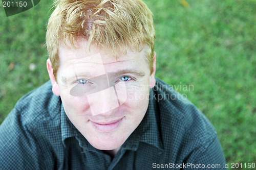 Image of Portrait of a blond man with striking blue eyes