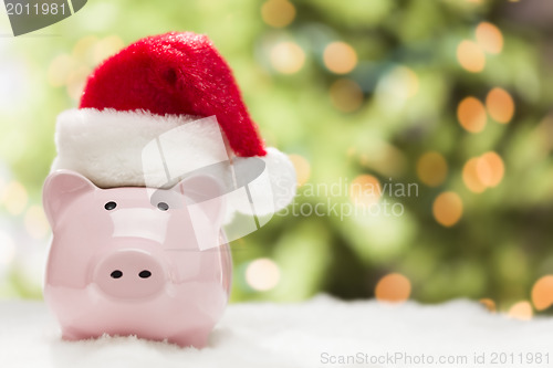 Image of Pink Piggy Bank with Santa Hat on Snowflakes