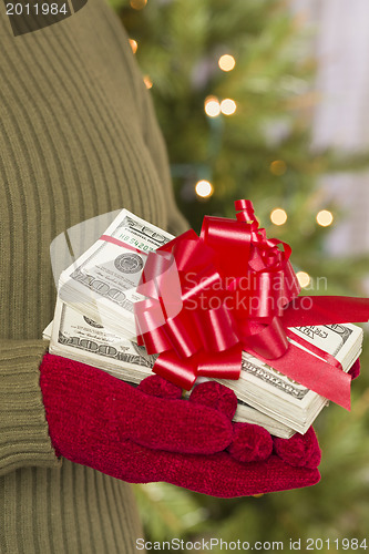 Image of Woman Wearing Mittens Holding Stacks of Money with Red Ribbon